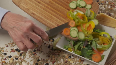 Preparing-vegan-vegetarian-lunch-meal,-mixed-vegetable-salad-in-white-dish