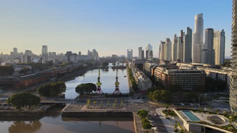 Aerial-establishing-shot-of-Puerto-Madero-docks-in-Buenos-Aires-city-at-golden-hour