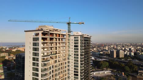 Aerial-parallax-shot-of-skyscrapers-under-construction-beside-La-Plata-river-in-Buenos-Aires