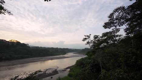 Slow-panning-shot-of-Misahualli-River-during-sunset-and-clouds-at-sky