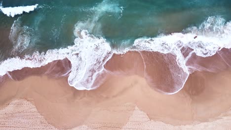 Aerial-Top-View-of-Ocean-Waves-Reaching-Beach-Shore