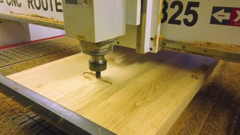 Cnc-router-machine-starts-rough-milling-process-on-oak-wooden-board