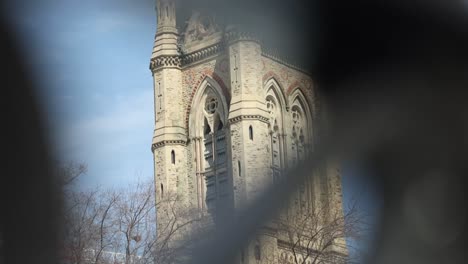 West-Block-Parliament-building-through-the-steel-gate-of-the-surrounding-walls-in-Ottawa,-Ontario