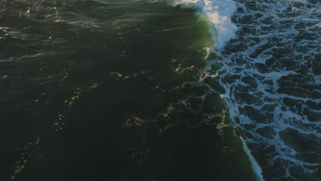 Aerial-top-down-view-of-ocean-waves-with-a-morning-sun-reflecting-off-the-water-during-sunrise-at-Miami-Beach-Gold-Coast-Australia