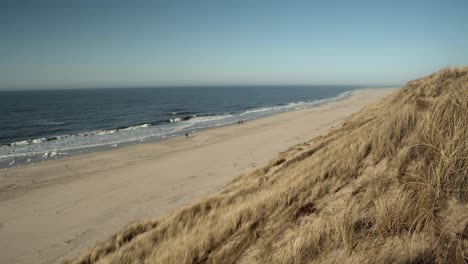 Beach-of-Sylt-on-a-sunny-day-with-people-walking-by