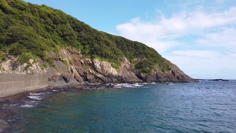 Coastline-of-Yakushima,-Pan-Across-Small-Harbor-on-Summer-Day