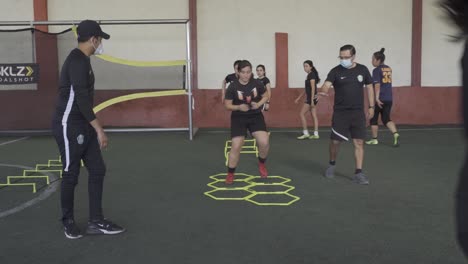 A-football-player-on-a-hexagonal-speed-and-agility-training-ladder-rings-in-the-field