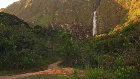 The-trailhead-leading-to-a-picturesque-tropical-waterfall-in-the-distance
