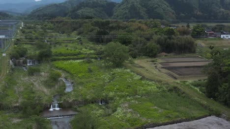 Mt-Daisen-in-Tottori-Prefecture,-Tilt-Down-Revealing-River-Construction