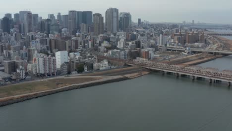 Umeda-District-and-Yodo-River,-Aerial-Tilt-Shot,-Japan