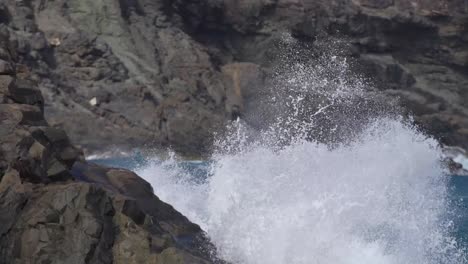 Waves-crashing-and-splashing-into-rocks-in-slow-motion
