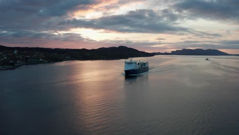 Cargoship-Samskip-Kvitbjorn-sailing-Norway-waters-during-beautiful-sunset---Rotating-aerial-with-Sotra-island-in-background