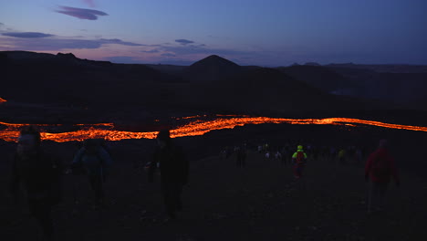 Panning-shot-of-tourist-visiting-long-lava-river-after-Eruption-in-the-evening
