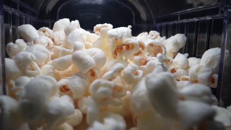 Close-up-shot-of-jumping-popcorn's-during-production-process-in-cinema,slow-motion