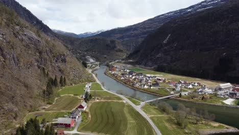 Modalen-river-and-farms---Showing-valley-with-farmland-houses-and-bridge---Norway-aerial