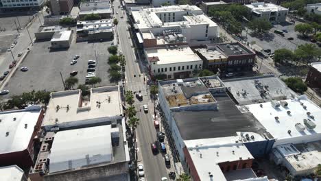 drone-flight-straight-down-East-8th-Avenue-in-Ybor-City,-Tampa,-Florida