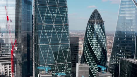 London-drone-shot-out-of-skyscraper-cluster-Gherkin-building