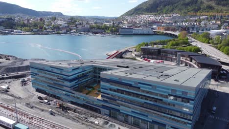 Aerial-approaching-Amalie-Skram-school-and-swimming-pool-building-ADO-Arena-in-Bergen-Norway