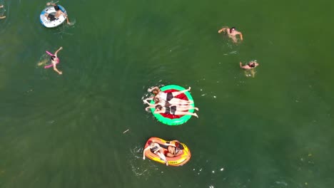 Aerial-still,-people-playing,-swimming,-floating-on-lake-in-summer