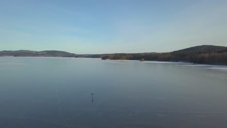 A-person-in-solitude-ice-skating-on-a-big-lake