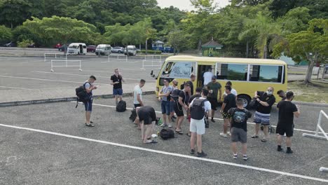 Group-of-tourists-getting-out-of-bus-ready-for-sightseeing-in-Dunn's-River-Fall
