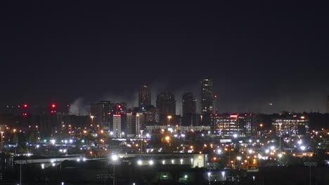 Time-lapse-of-beautiful-night-cityscape-with-burning-fire-smoke-at-the-background