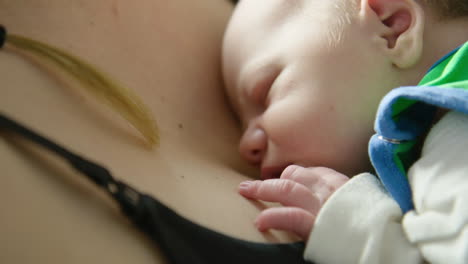 CLOSE-UP---Beautiful-newborn-baby-snuggles-close-to-mother