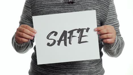 A-person-holding-a-sign-with-the-message-and-the-word-"safe