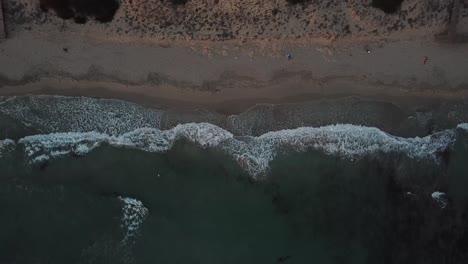 Top-Down-View-Of-Tranquil-Beach-With-Foamy-Waves-Washing-On-Shore-In-Menorca,-Spain---aerial-static-shot