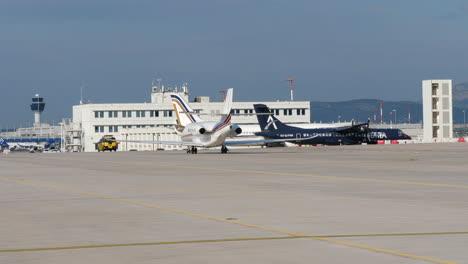 Citation-Latitude-Jet-Following-A-Follow-Me-Car-At-The-Airport-In-Athens,-Greece-On-A-Sunny-Day