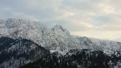 Rough-And-White-Rocky-Mountain-Facade-And-Snow-capped-Forest-In-Winter-Day-in-Poland---aerial-shot