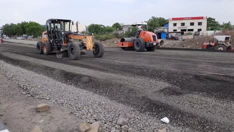 Worker-Leveling-Fresh-Asphalt-On-A-Road-Construction-Site