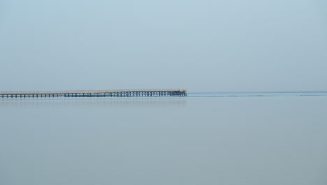 Empty-wooden-jetty-pier,-reflected-in-calm-ocean-in-Sharm-El-Sheikh