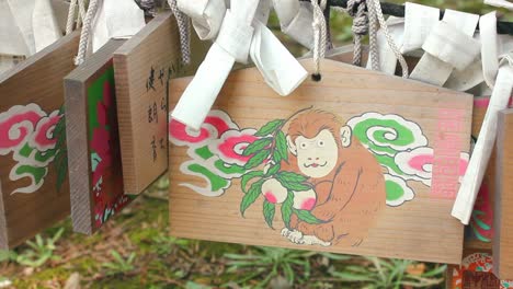 Wooden-plate-with-drawing-of-a-monkey-in-Shinto-Shrine