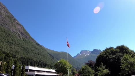 Norway-flag-blowing-in-wind-during-summer-day-in-national-romantic-landscape---Static-Loen-Norway