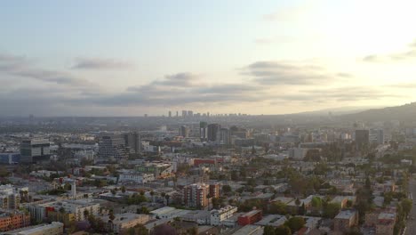 Aerial,-panoramic-view-of-the-cityscape-and-sunset,-drone-view