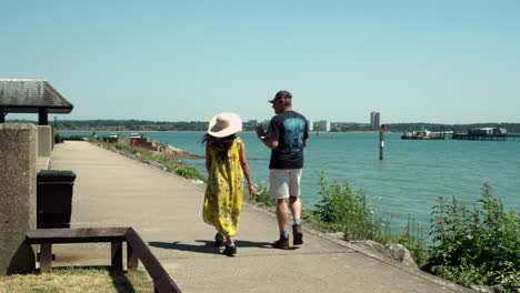 An-Indian-tourist-couple-enjoying-a-walk-at-Hythe-Marina-adjacent-to-Southampton-waters,-England,-UK