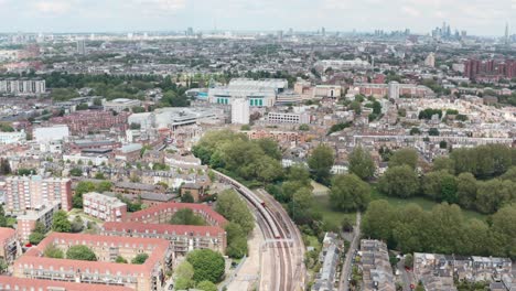 Drone-shot-over-district-line-underground-trains-towards-Stamford-Bridge-chelsea-stadium-London