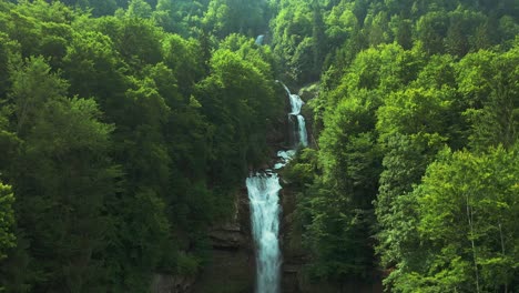 Beautiful-waterfall-in-alpine-forest,-Giessbachfall-Switzerland,-aerial