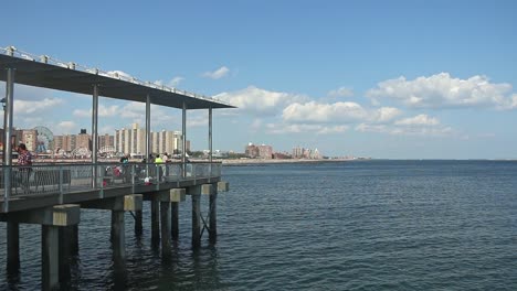 Coney-Island-Fishing-at-Pier,-Fisherman,-New-York,-USA-July-29,-2021