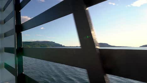 A-passengers-view-from-car-deck-and-out-to-open-sea---Onboard-Hydrogen-powered-ferry-Hydra-from-Norled-crossing-Hjelmeland-to-Nesvik-Norway---Summer-day-view-through-steel-gratings