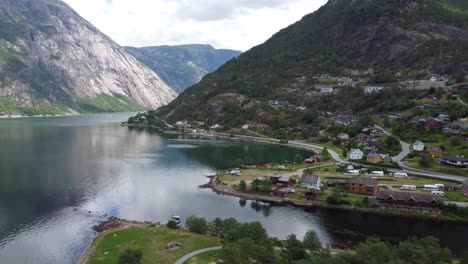 Eidfjord-seafront-view---Sideways-moving-aerial-with-eidfjord-river-and-Simadalen-valley-in-background