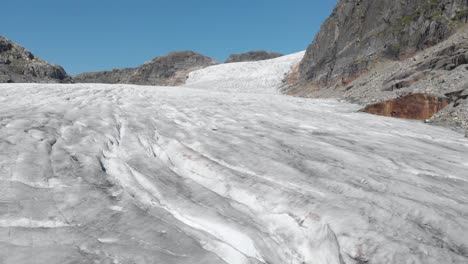 Glacier-ice-sheet-crevasses-and-cracks,-aerial-reveal-Hardanger-Glacier-Norway