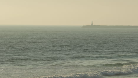Distant-View-Of-Cape-Mondego-Lighthouse-On-A-Misty-Morning-In-Figueira-da-Foz,-Portugal