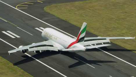 aerial-trailing-shot-of-an-airbus-380-landing-and-turning-on-taxiway