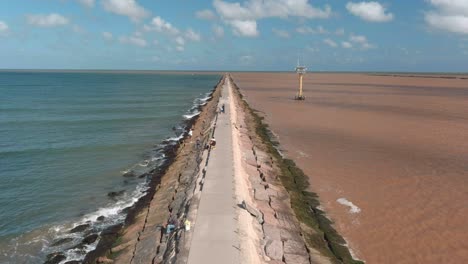 Establishing-aerial-shot-of-the-Surfside-beach-trail-in-Lake-Jackson,-Texas-off-the-Gulf-of-Mexico