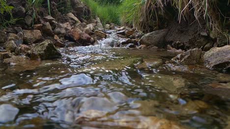 Slow-motion-of-wild-mountain-river-water-stream-flowing-through-rocks