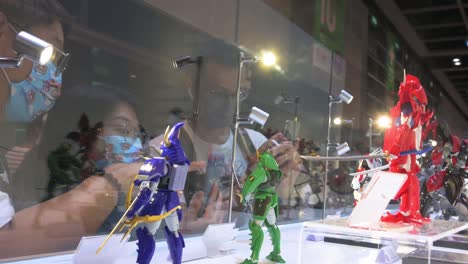 Visitors-look-at-branded-character-figures-while-attending-the-Anicom-and-Games-ACGHK-exhibition-event-in-Hong-Kong
