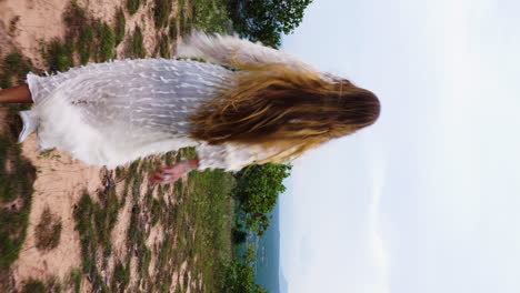 An-attractive-woman-with-long-healthy-hair-running-towards-spectacular-nature-view