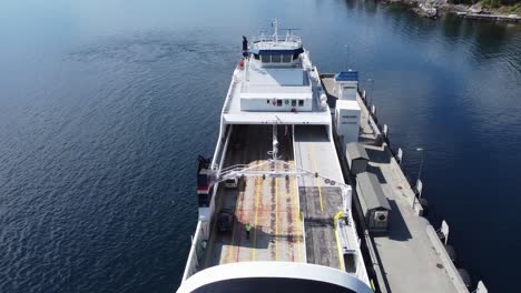 Car-ferry-Mf-Oppedal-loading-cars-in-the-port-of-Lavik-in-sogn-norway---Static-aerial-over-deck-looking-down-at-crewmwmber-and-cars-driving-onboard---Norled-company